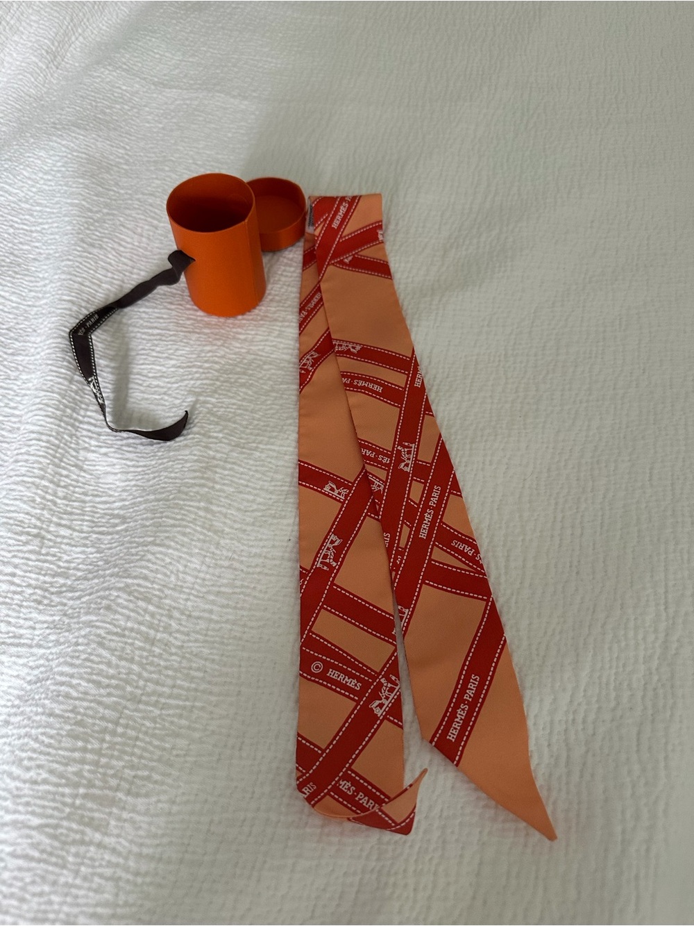 Hermès Orange Silk Twilly with Graphic Ribbon Print